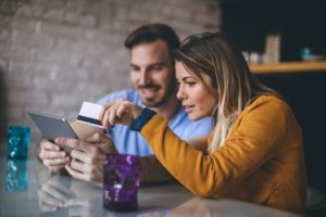 Man and Woman viewing video & buying online